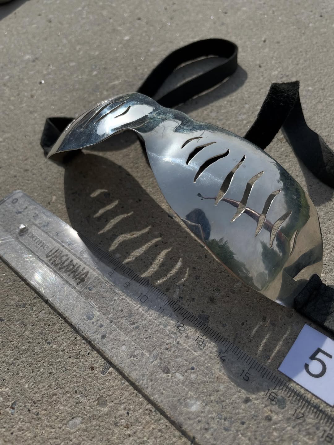 Bone cut silver goggles, three-quarter view showing slit cuts