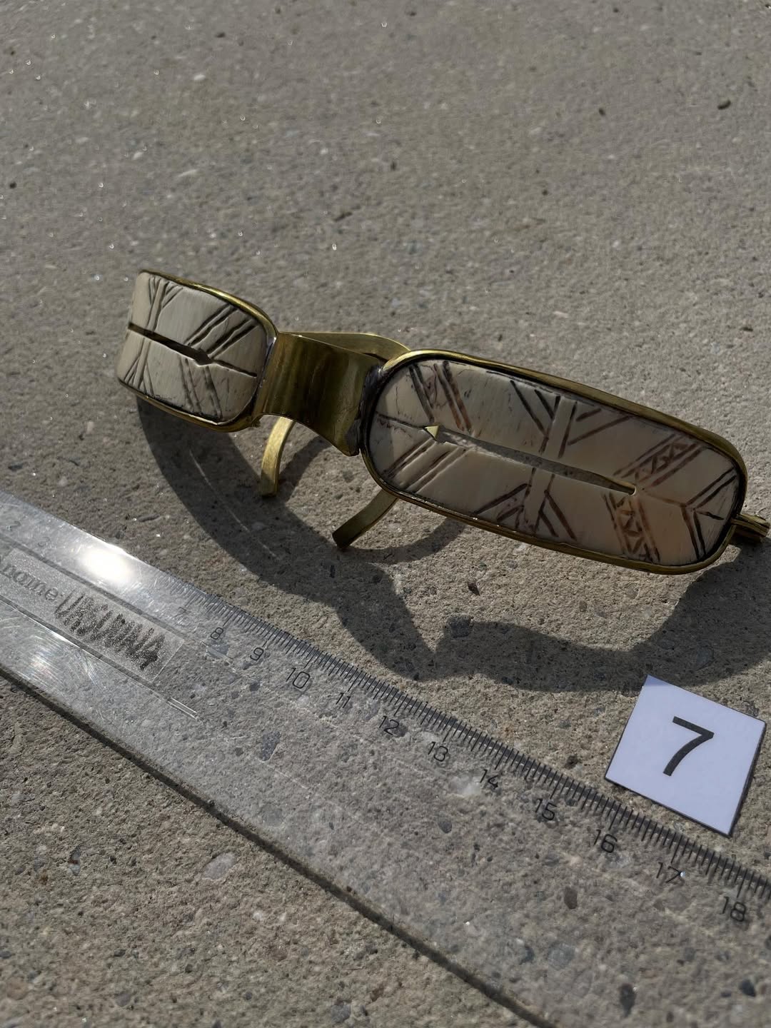 Mammoth ivory goggles, three-quarter view showing carved ivory inserts